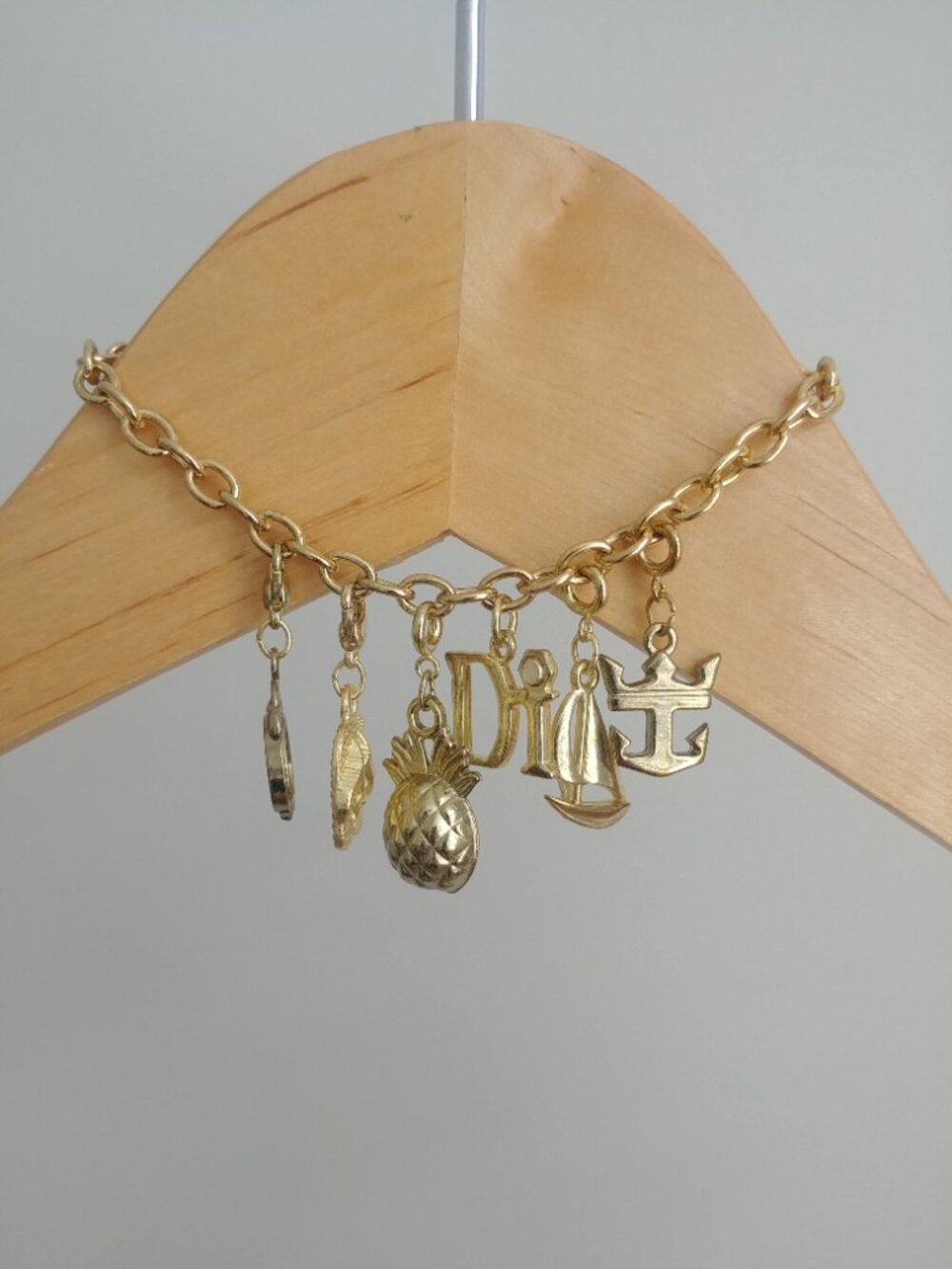 Gold tone charm link bracelet with six charms